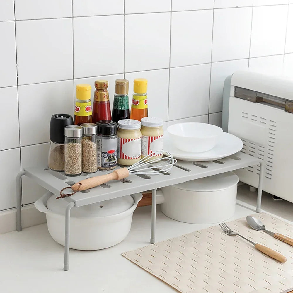Shelf riser organizing a kitchen cabinet