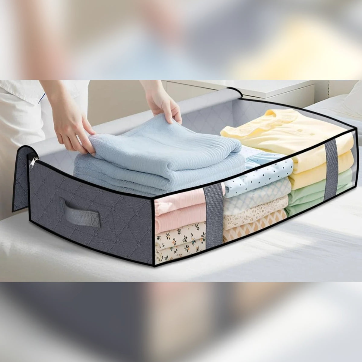 Foldable under-bed storage bag filled with folded clothes and linens